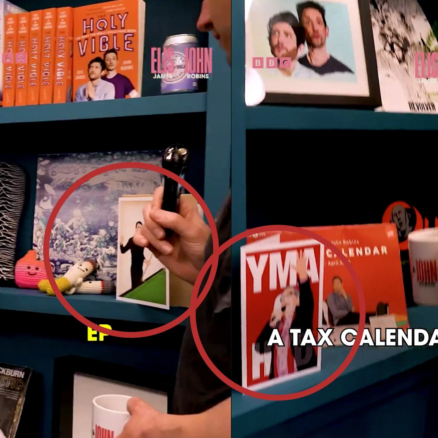 A blue bookshelf containing various books, magazines, and decor. Some books feature prominent titles such as "Holy Vibe" and "A Tax Calendar." There is a framed photograph of two smiling people, a novel titled "The Dead" by James Joyce, and some smal