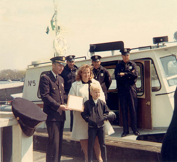 Henry's wife and Henry Jr. standing in front of Launch 5 with the dedication plaque