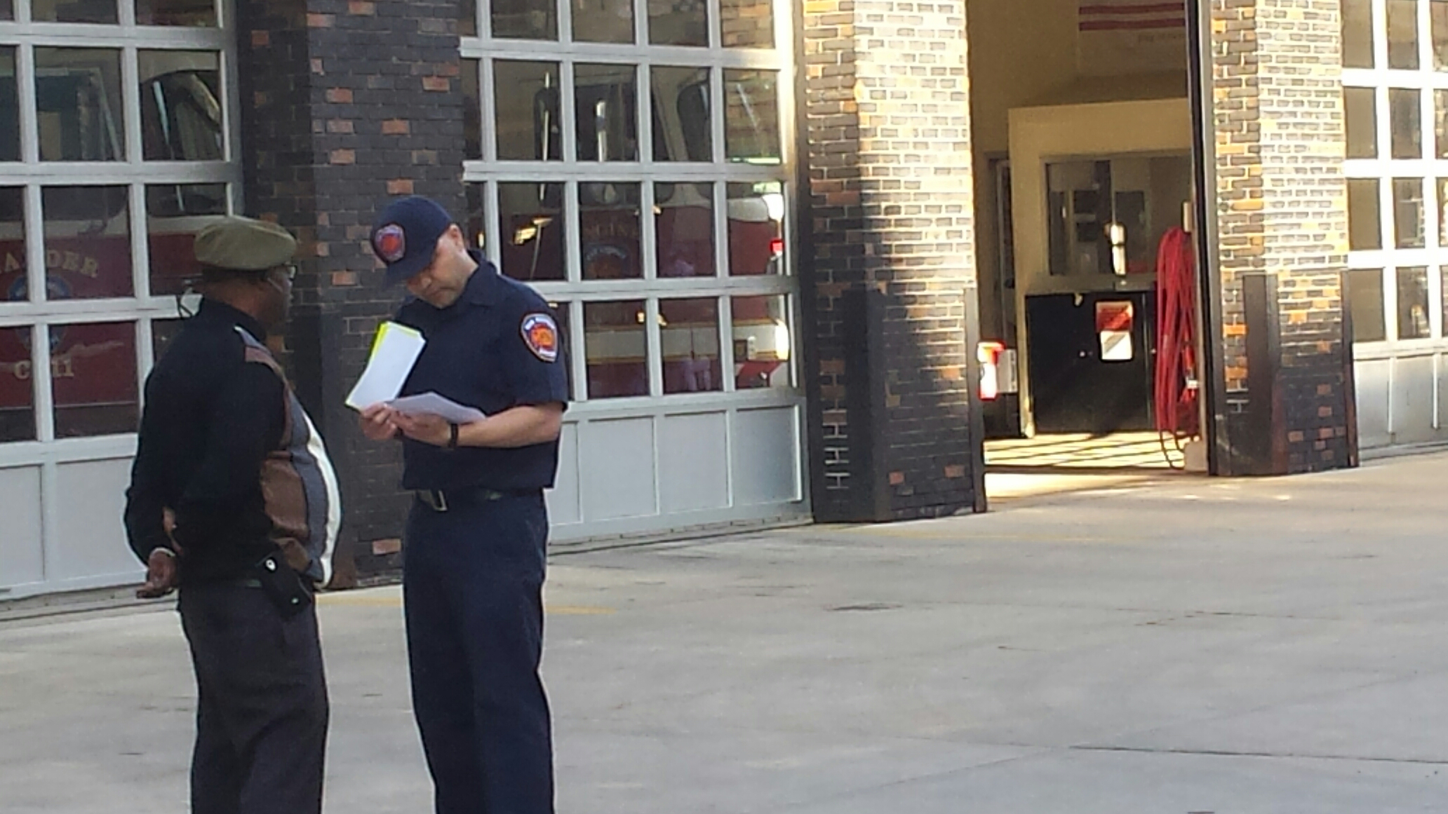 Tony Peppers speaking with a representative from New Rochelle Fire Station