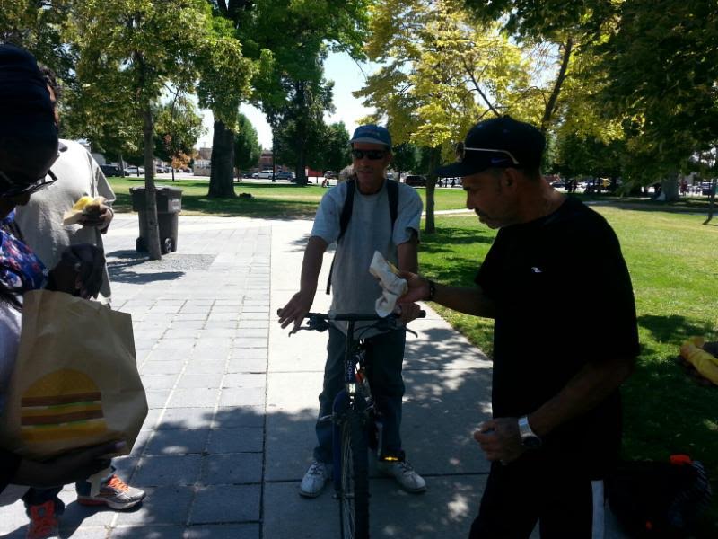 HCH Chairwoman Alison Mayo hands out sandwiches to the homeless