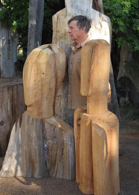 The artist with two works in cedar outside Denman Island studio .