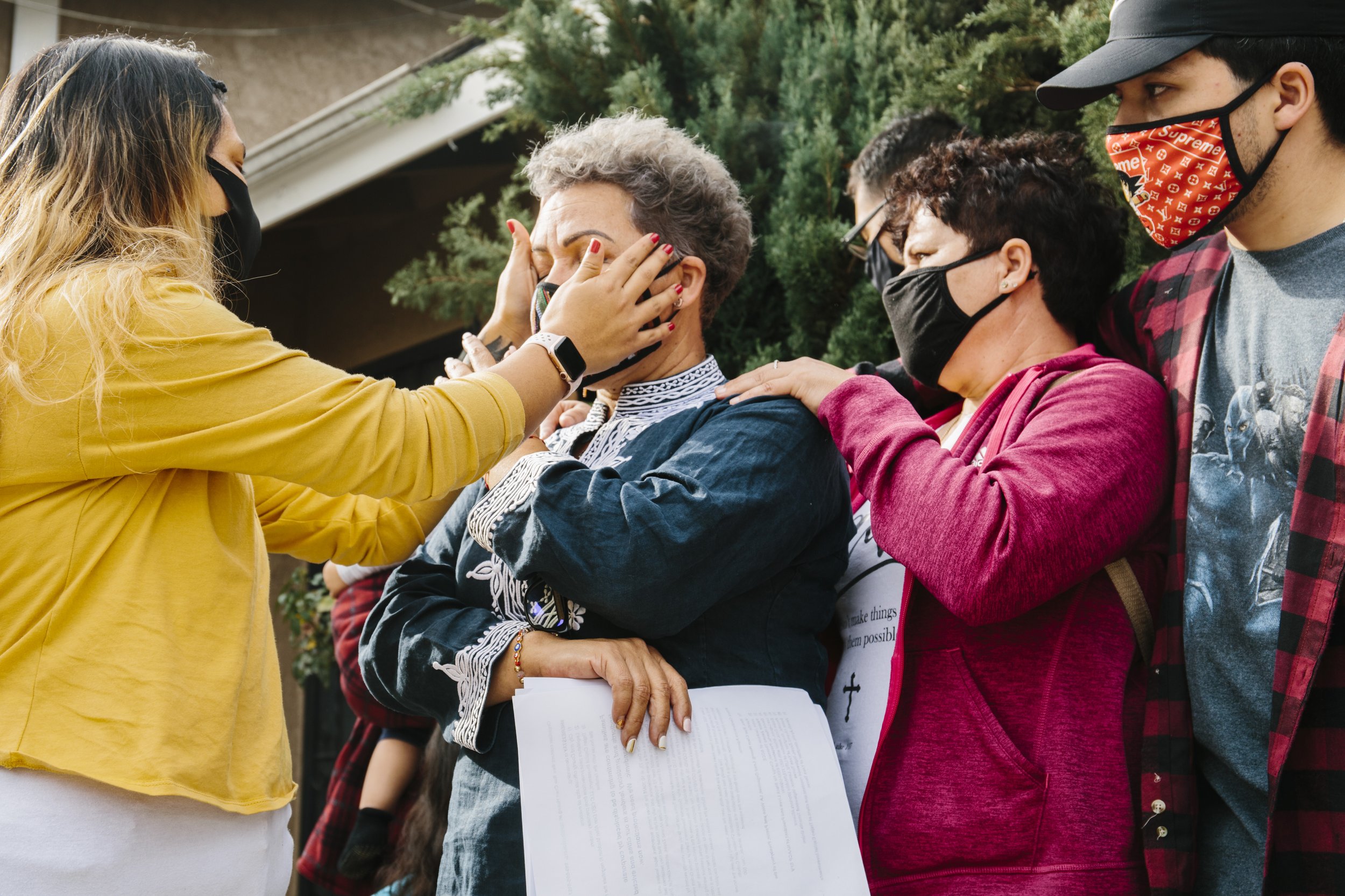  Family is comforted while being faced with eviction from their Los Angeles home. Los Angeles. December 2020.  