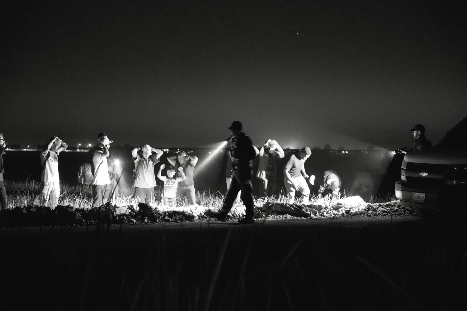  CBP searched for and found a group of migrants hiding in a field near the border wall. Arizona. 2022. 