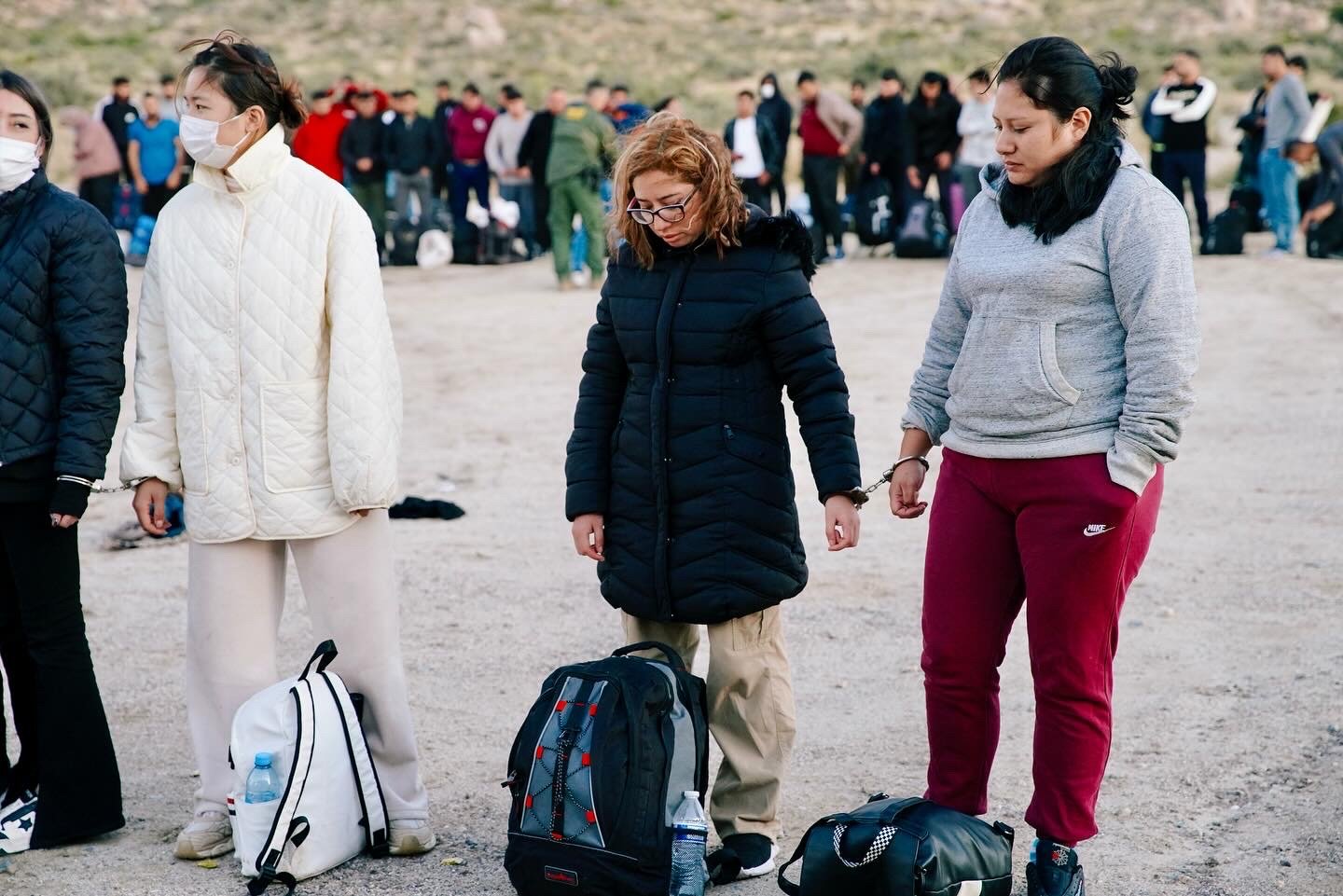 Jacumba Springs Migrants handcuffed before boarding a CBP bus