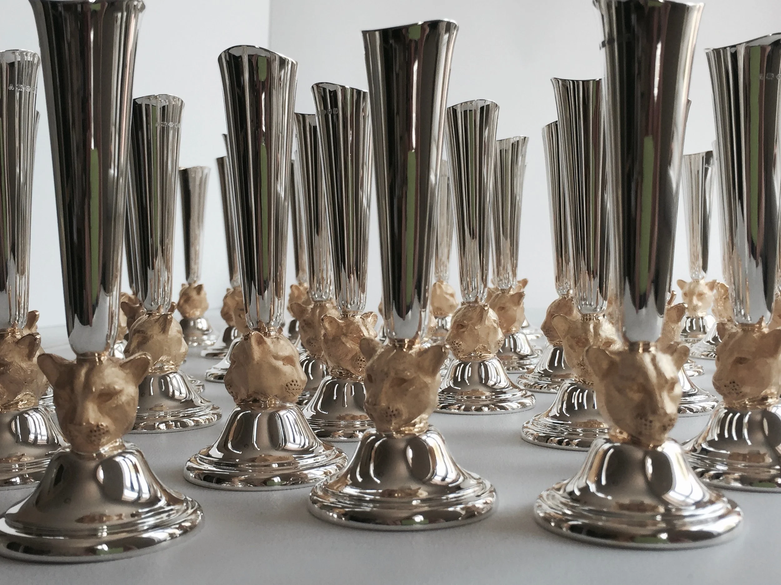 Close up image of multiple bud vases with leopard head