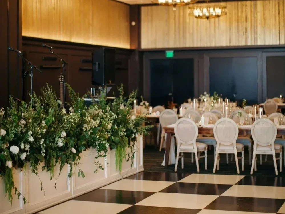 Modern wedding reception with lush greenery florals and candlelight at The Edgewater Hotel in Madison, Wisconsin by 1209 Creative.