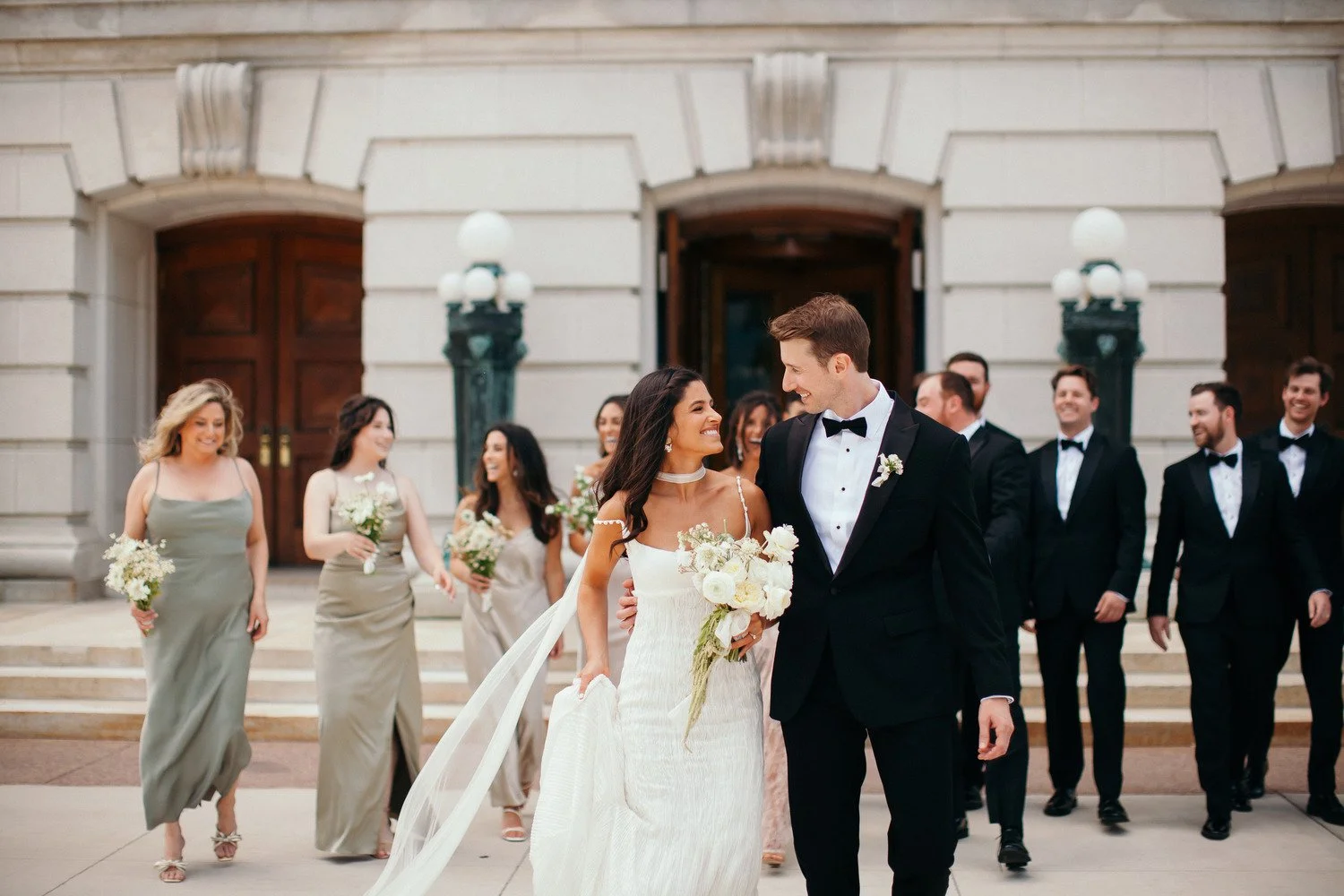 Elegant bridal party with white wedding florals at The Edgewater Hotel in Madison, Wisconsin, designed by 1209 Creative.