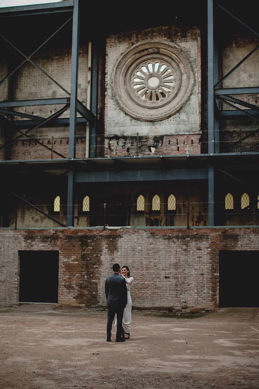 Wedding couple portrait inside Monroe Street Abbey in Phoenix Arizona, featuring an industrial historic venue and editorial wedding florals designed by 1209 Creative