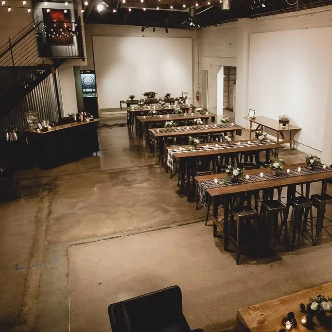 Industrial wedding reception setup at Monroe Street Abbey in Phoenix Arizona featuring long tables and modern floral styling by 1209 Creative for an editorial wedding design