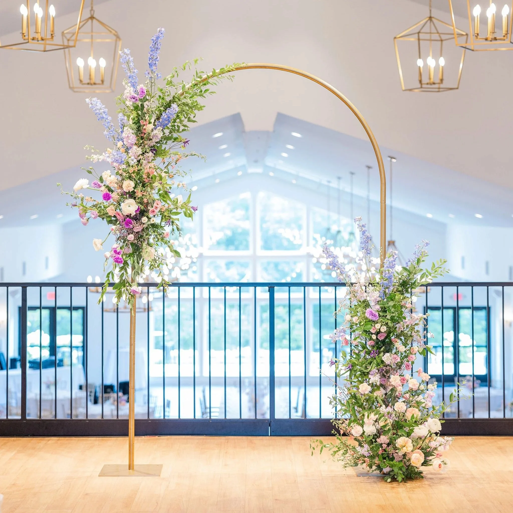 Wedding ceremony arch with lush floral installation designed by 1209 Creative at The Eloise in Madison Wisconsin, featuring pastel florals with an elevated editorial wedding style