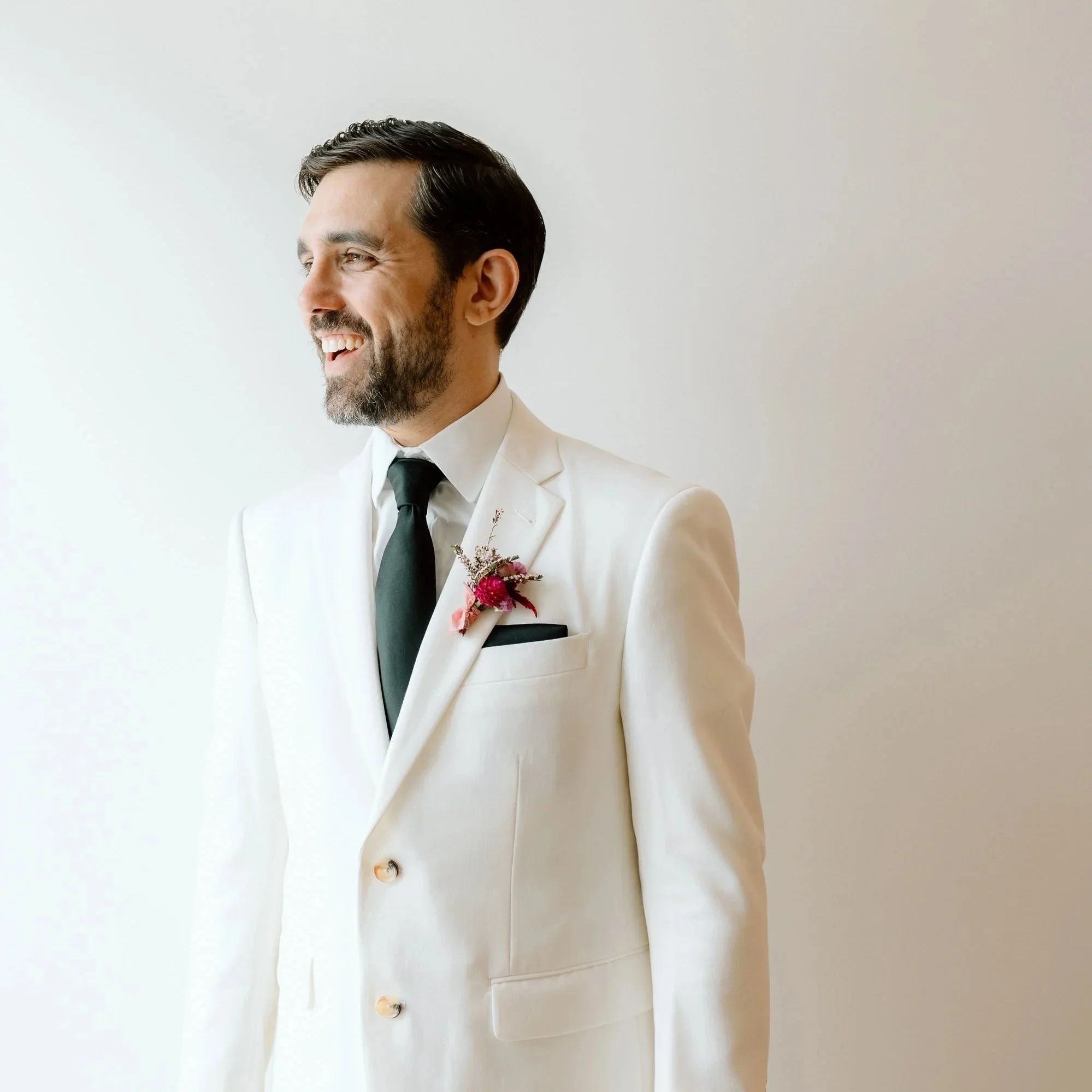 Groom wearing a modern floral boutonniere designed by 1209 Creative for a Milwaukee Wisconsin wedding