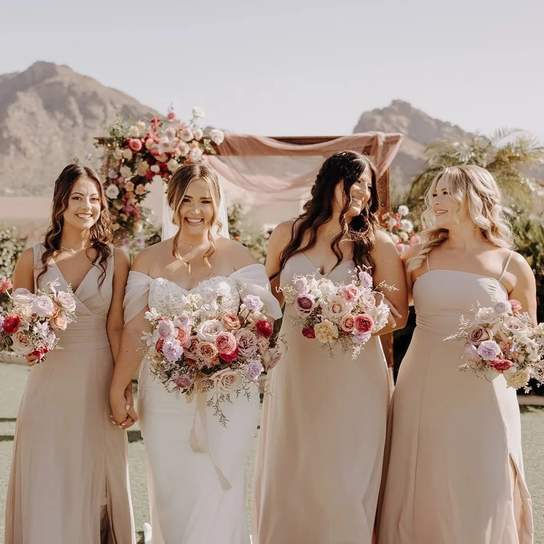 Bride and bridesmaids holding wedding bouquets designed by 1209 Creative at Camelback Inn in Phoenix Arizona, set against a desert landscape with an elevated editorial floral style