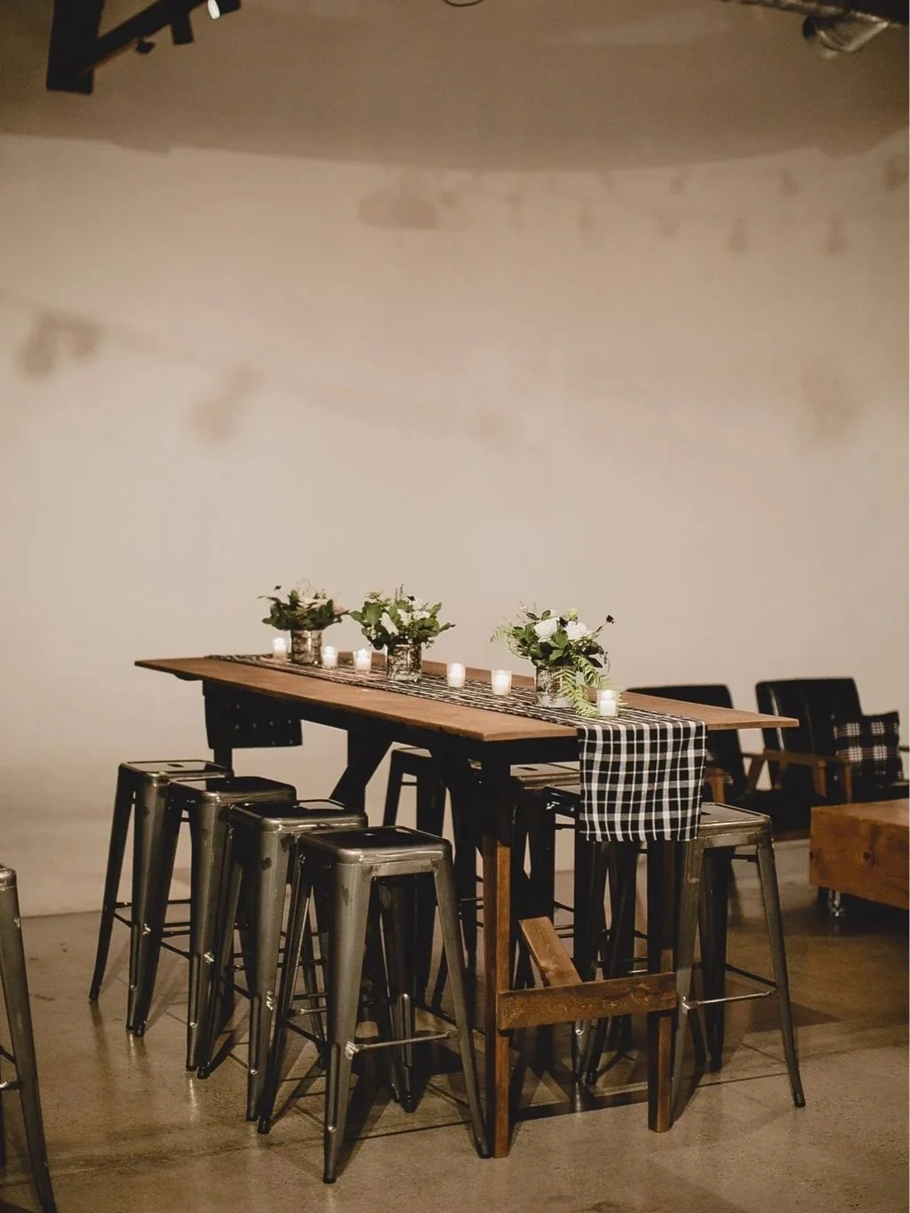 Communal reception table with simple floral accents styled by 1209 Creative at Monroe Street Abbey in Phoenix Arizona, showcasing modern editorial wedding design