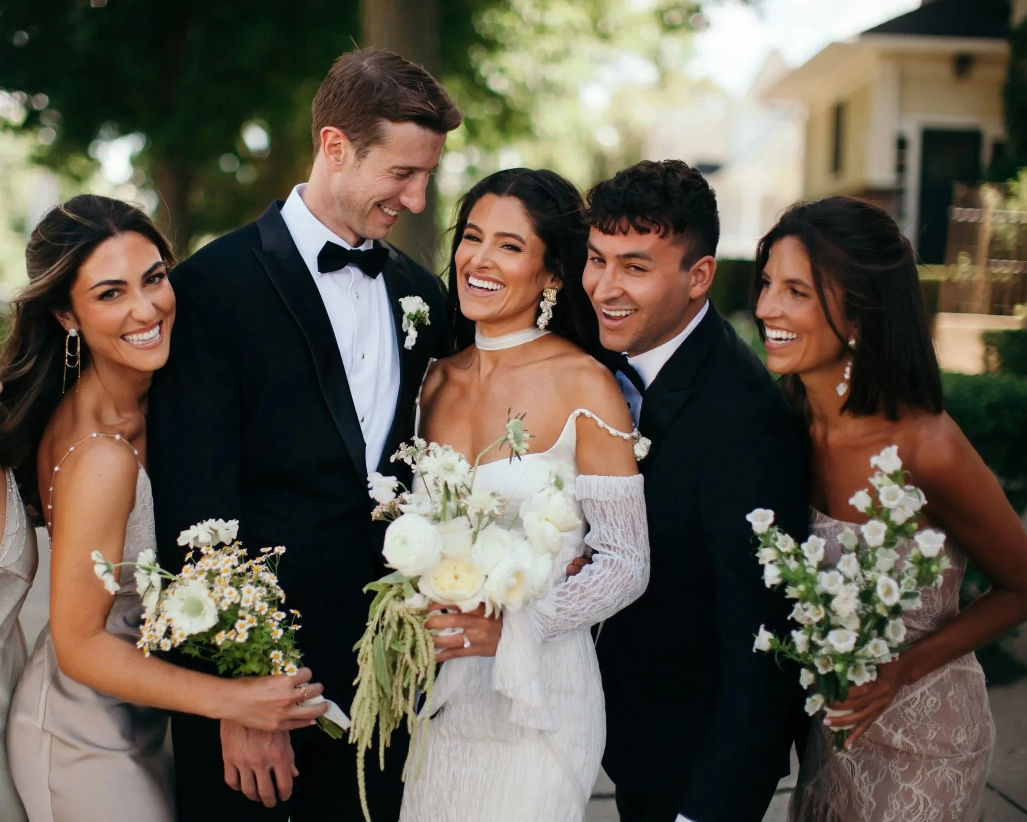 Wedding party with modern white bouquets at The Edgewater Hotel in Madison, Wisconsin, featuring floral design by 1209 Creative.