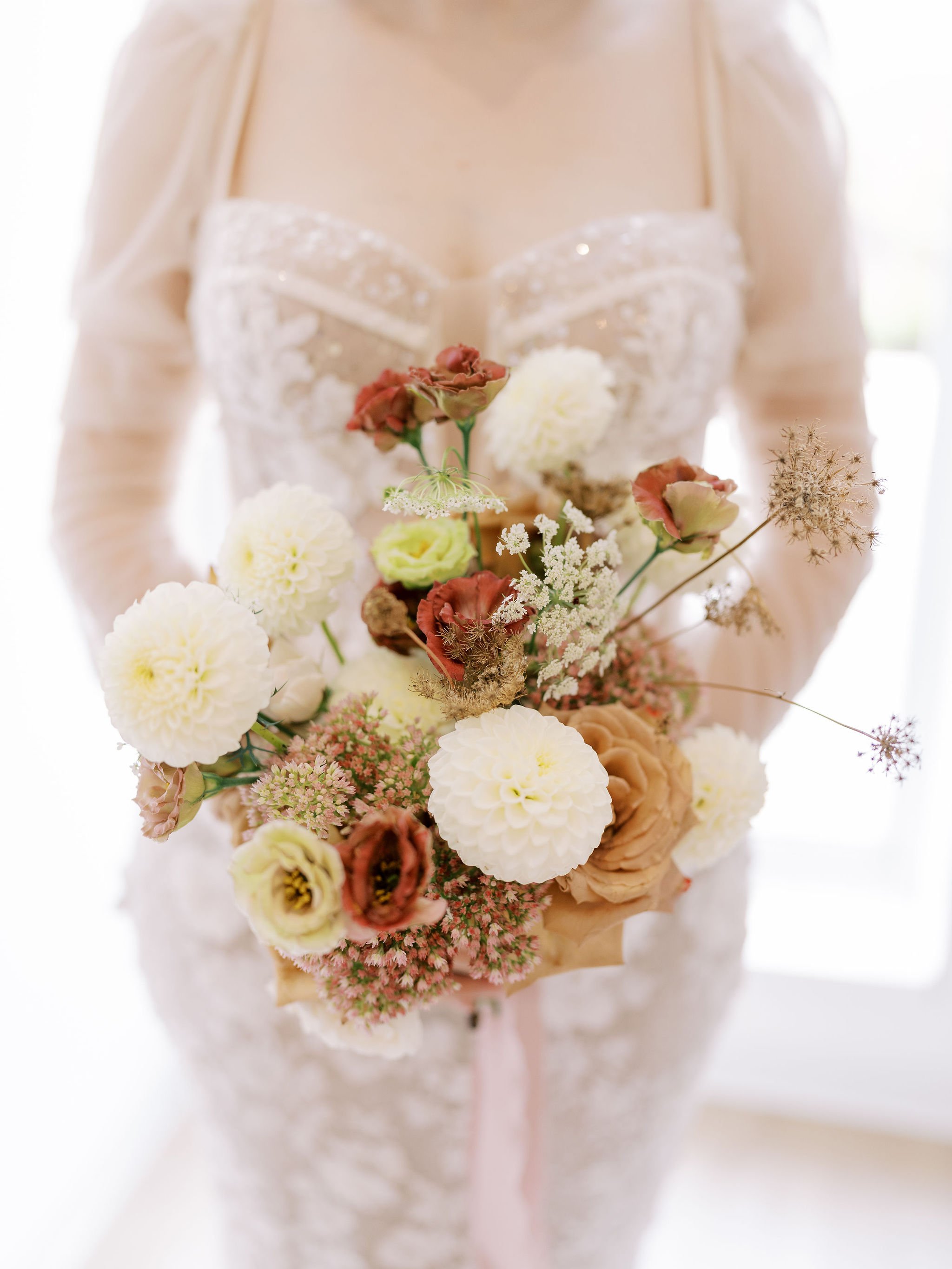 Bride holding an editorial wedding bouquet designed by 1209 Creative for a wedding at The Eloise in Madison Wisconsin, showcasing soft romantic florals with a modern aesthetic