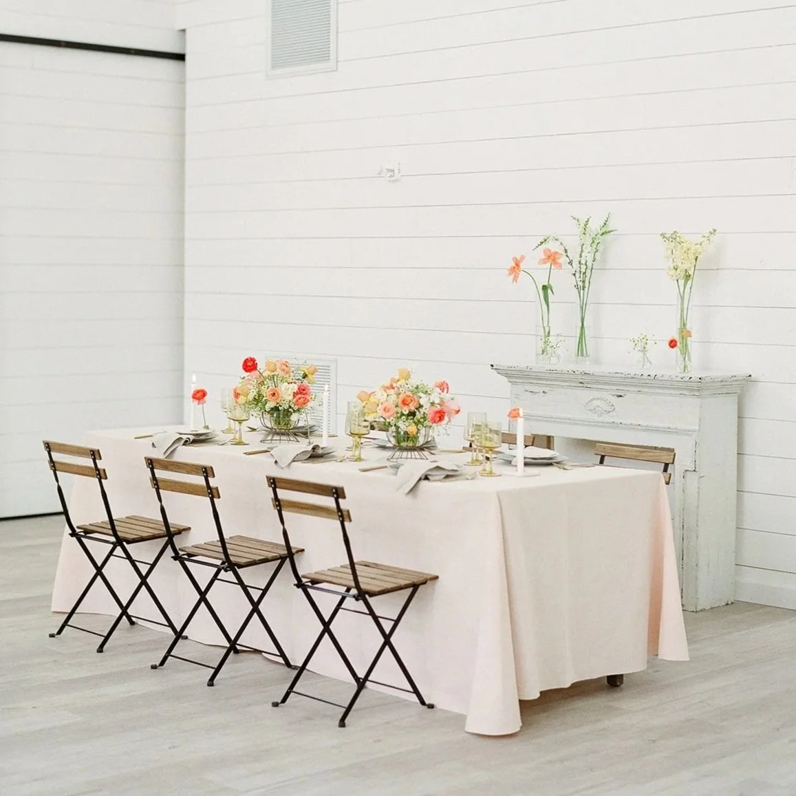 Long reception table with modern floral arrangements designed by 1209 Creative at Providence Vineyard in Hebron Illinois, styled with soft linens and colorful wedding florals