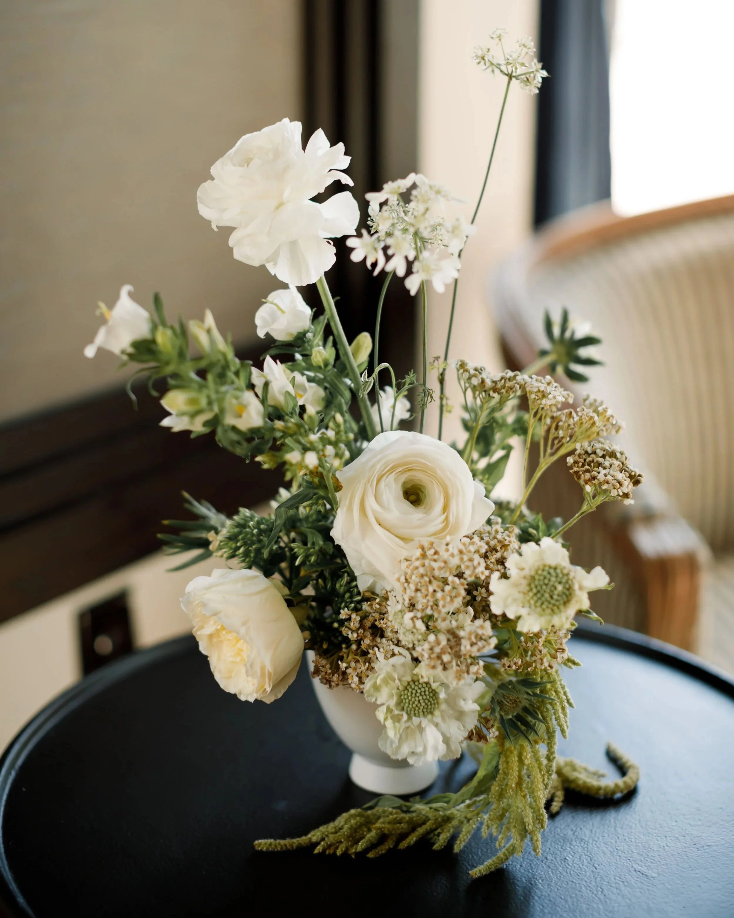 Modern white wedding centerpiece with ranunculus and airy florals at The Edgewater Hotel in Madison, Wisconsin, designed by 1209 Creative.