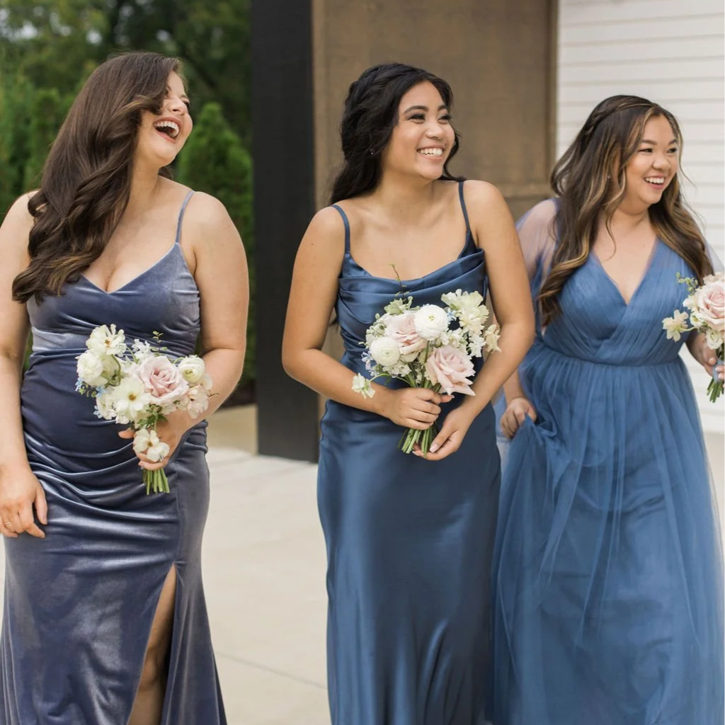 Bridesmaids in blue dresses holding soft romantic wedding bouquets designed by 1209 Creative at a Milwaukee Wisconsin wedding