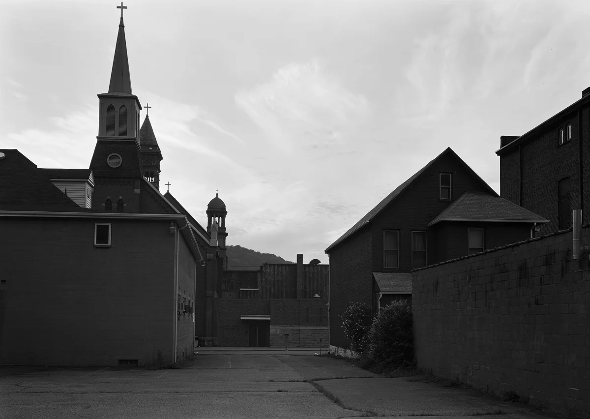 Two Churches are evident in this view from a lot bordering the Former S&C Branch looking Northwest. The Steeple in the foreground belongs to the 1891 Zion Lutheran Church the two further towers are part of the Cathedral of Saint John Gualbert built in 1895.