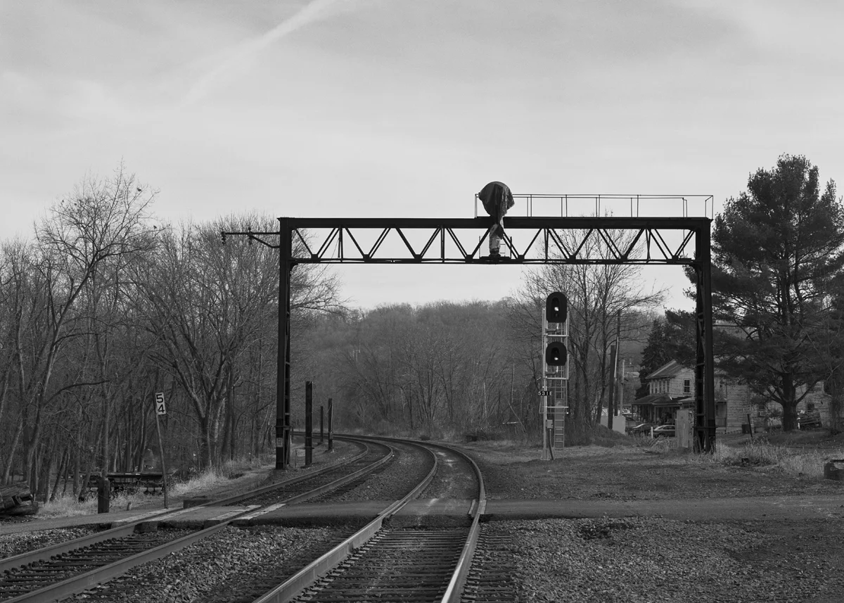 Former location of Cly block station and interlocking. The tower actually sat just around the curve, with this bridge supporting the eastbound home signals. Note the extra space on the right, this area was once four tracks wide with the Northern Central and York Haven Lines coming down from Enola. Four miles east of here the NC would diverge from the York Haven Line at Wago Junction. This location was once part of the electrified low-grade line, evident by the cut steel posts on the left side of the tracks. Norfolk Southern has been doing considerable work here replacing rail, signals and general clean-up. After making this photo the former PRR signal bridge would fall, being cut up, further eliminating the visual clues that speak to the heritage of this line.
