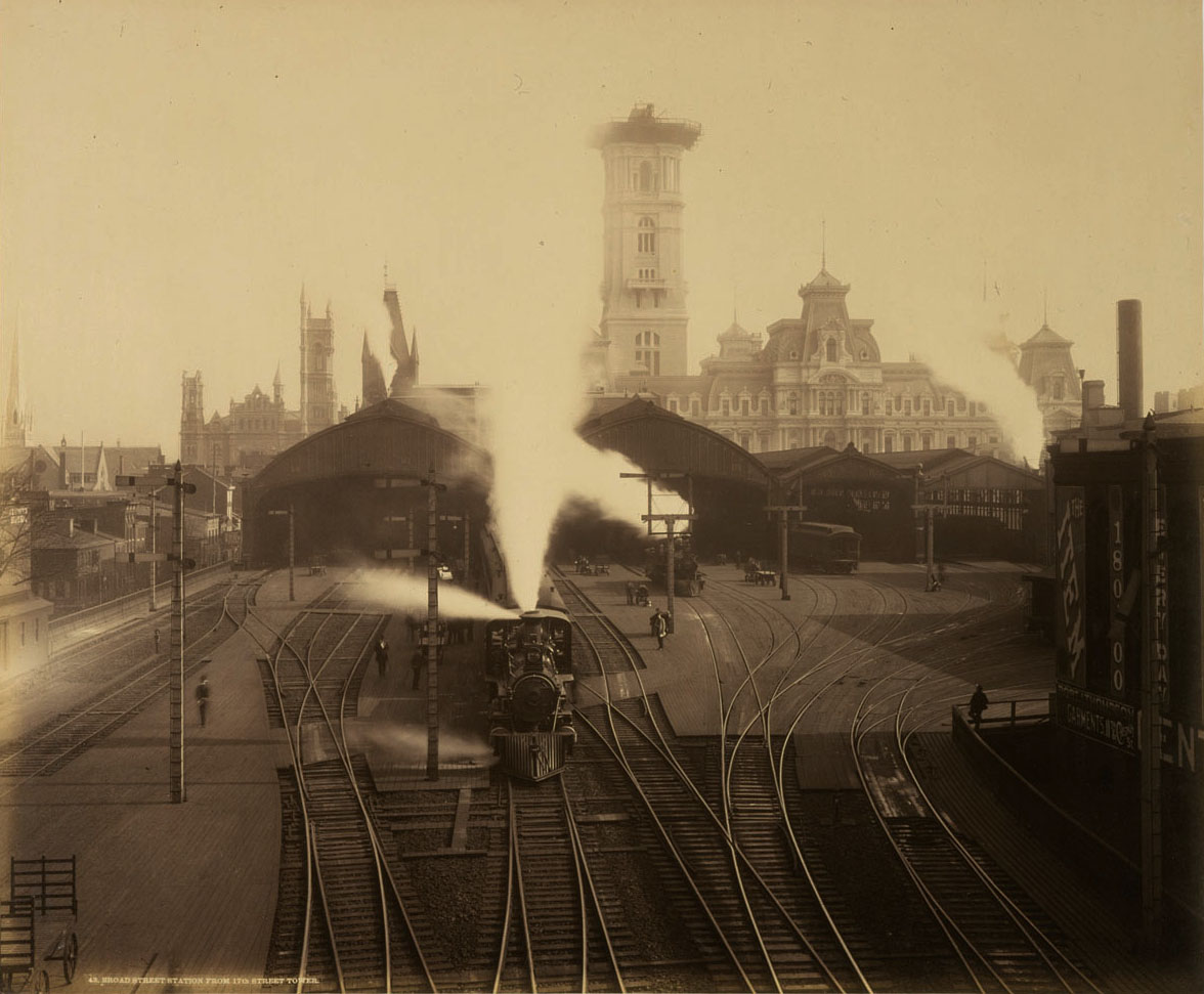 1891 photograph of the original Broad Street Station reveals a terminal that is less than one year from undergoing "modernization" by noted architect Frank Furness. During that project the station would see the elimination of the multiple train sheds in favor of a single glass and iron shelter covering 16 tracks that measured roughly 600’ long, 300 wide and 100 feet above the tracks. Note the ongoing construction of Philadelphia City Hall, including the pedestal that the iconic William Penn statue will stand on. William H. Rau photograph, Collection of American Premier Underwriters, Inc. 