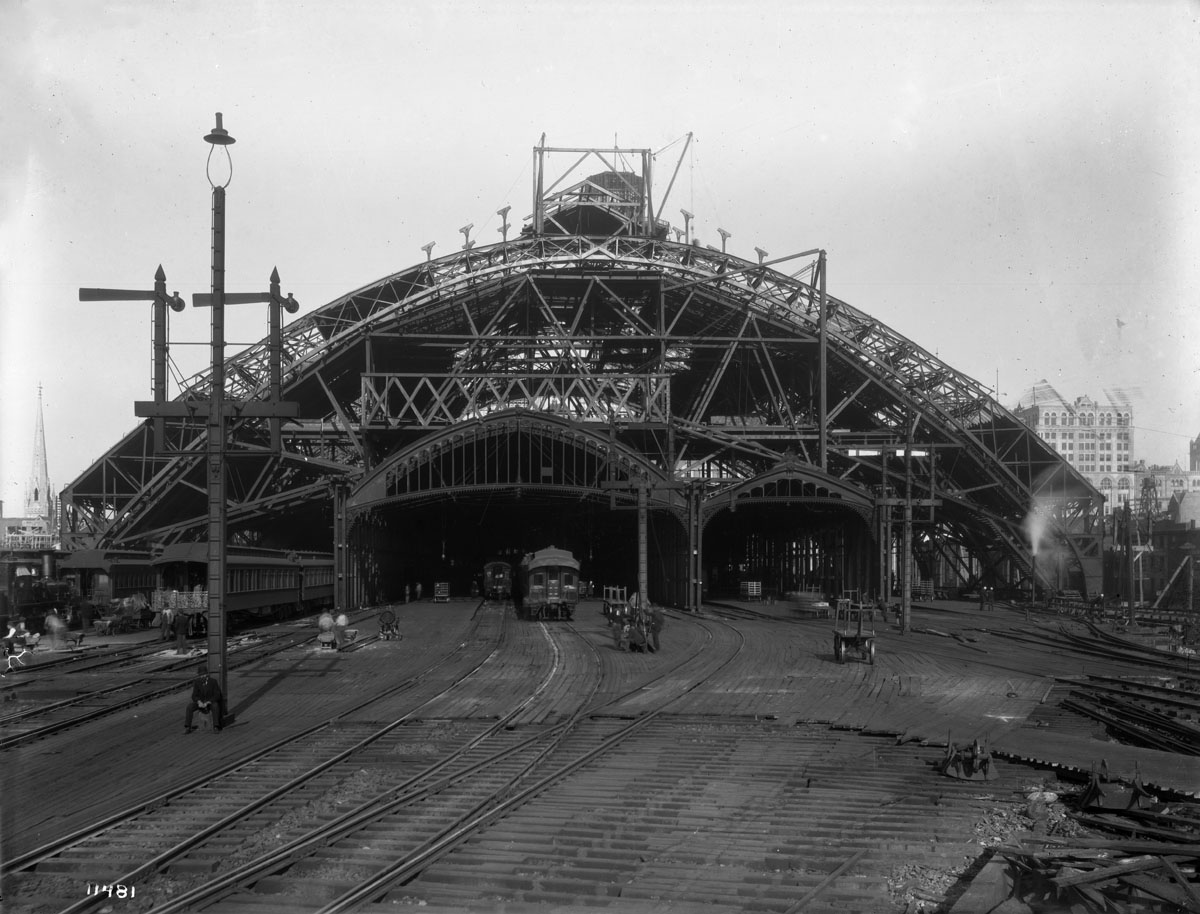 This image illustrates the changes to Broad Street Station during the 1892 modernization. Note that the railroad left the original canopies in place where possible to protect passengers until the new shed was complete. Despite the heavy construction the railroad would not allow the project to interrupt passenger service. This was typical practice on the Pennsylvania Railroad. William N. Jennings photograph, Collection of Library Company of Philadelphia. 