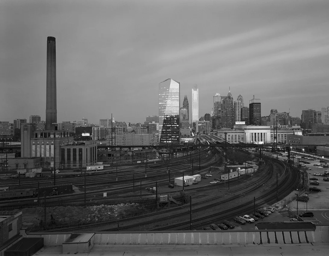 This view reveals a perspective of the finished Philadelphia Improvements showing how the Pennsylvania Railroad's efforts continue to serve the traveling public today. Seventy six years after the 30th Street Station complex opened, the matching steam plant and neighboring Pullman commissary would be demolished to make way for a parking lot and maintenance facility for Amtrak. Just two weeks after this photo the landscape would change yet again with the removal of the iconic steam plant, known affectionately to Drexel University students as the Drexel Shaft.