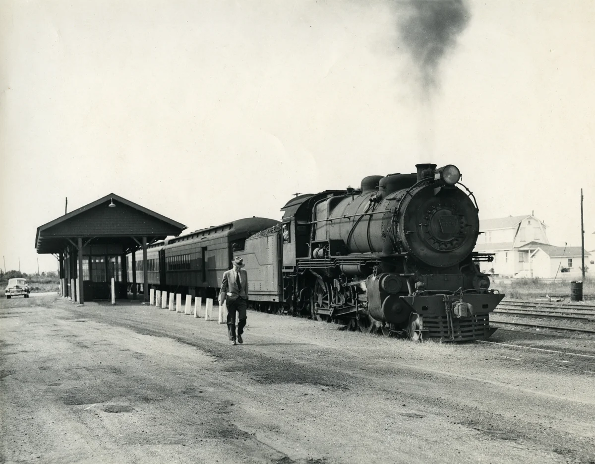 A lone commuter detrains from a Pennsylvania-Reading Seashore Lines train at the Gardens Station on the Ocean City Branch, October 1950. This facility was located between North Street and Battersea in the neighborhood along modern day Sindia Road and was abandoned in late 1958. It was photographs like this that captivated me at an early age and today hangs in my office to remind me of my early curiosity of railroad history. Photograph by Robert L. Long, collection of the author.