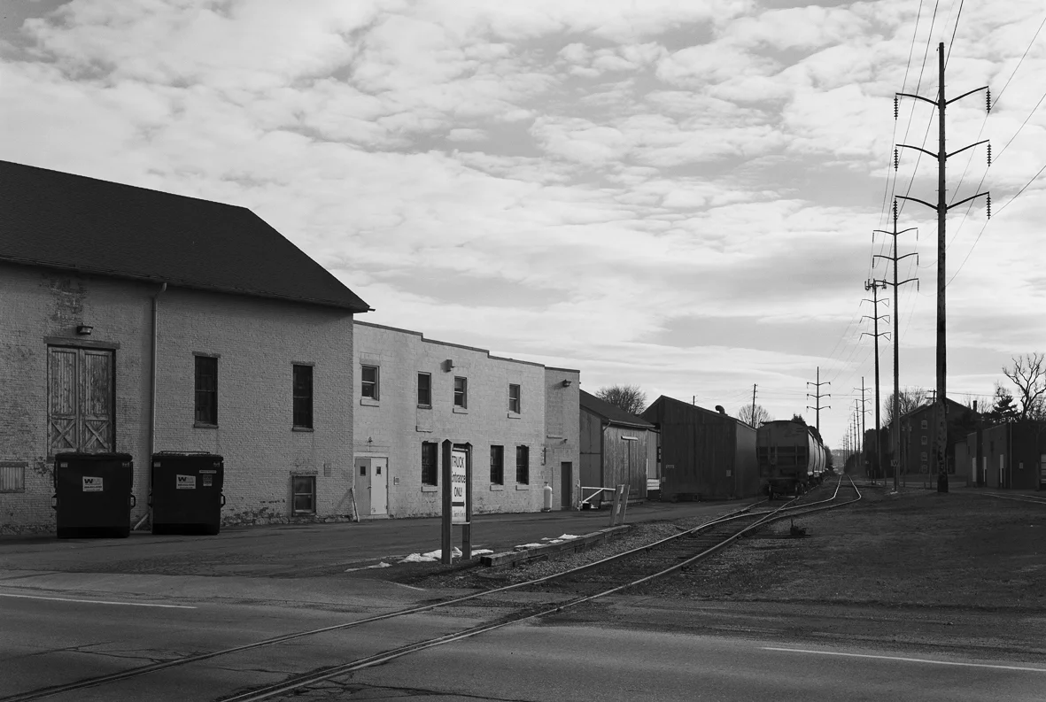 This surviving segment of the Reading and Columbia branch crosses Main Street in Salunga-Landisville south of the connection with the PRR continuing to the East Hempfield Township line to serve several industries. Today this industrial track is served by Norfolk Southern crews and includes several consignees like the lumber yard immediately behind the photographer. 