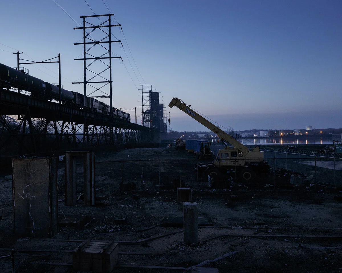 Construction waits as a late running inbound crude train crosses the Delair Bridge into Southern New Jersey during the April Outage. This week marks the sixth and final shoot for Conrail documenting the Delair Improvements program.