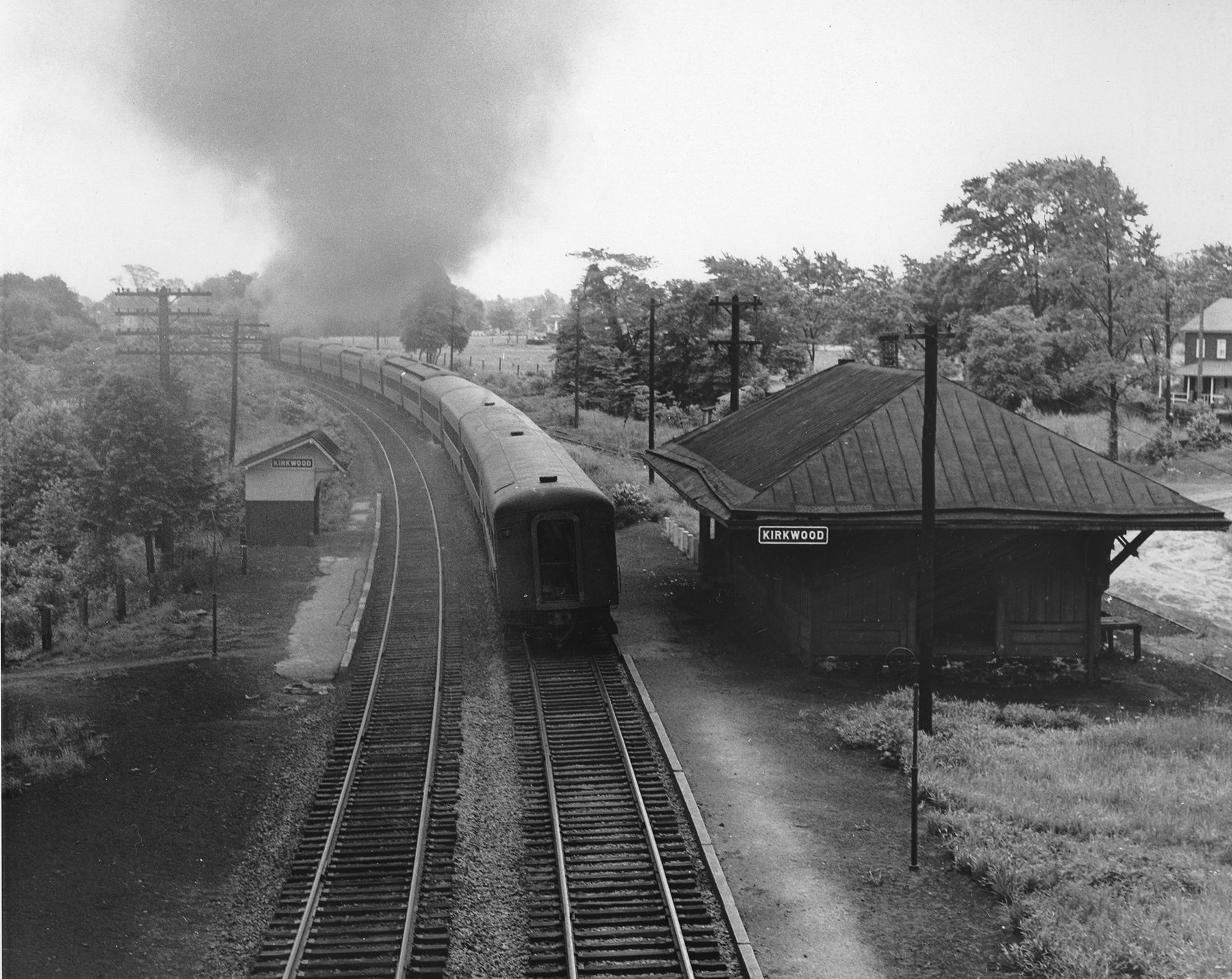 Southbound PRSL train passes through Kirkwood, New Jersey with PRR K-4 class locomotive 8746 and eleven cars, circa Summer of 1950. The Kirkwood station is actually where the modern day Lindenwold Station is for both New Jersey Transit and the PATCO high speed line. Photography by Robert L. Long, Collection of William Gindhart