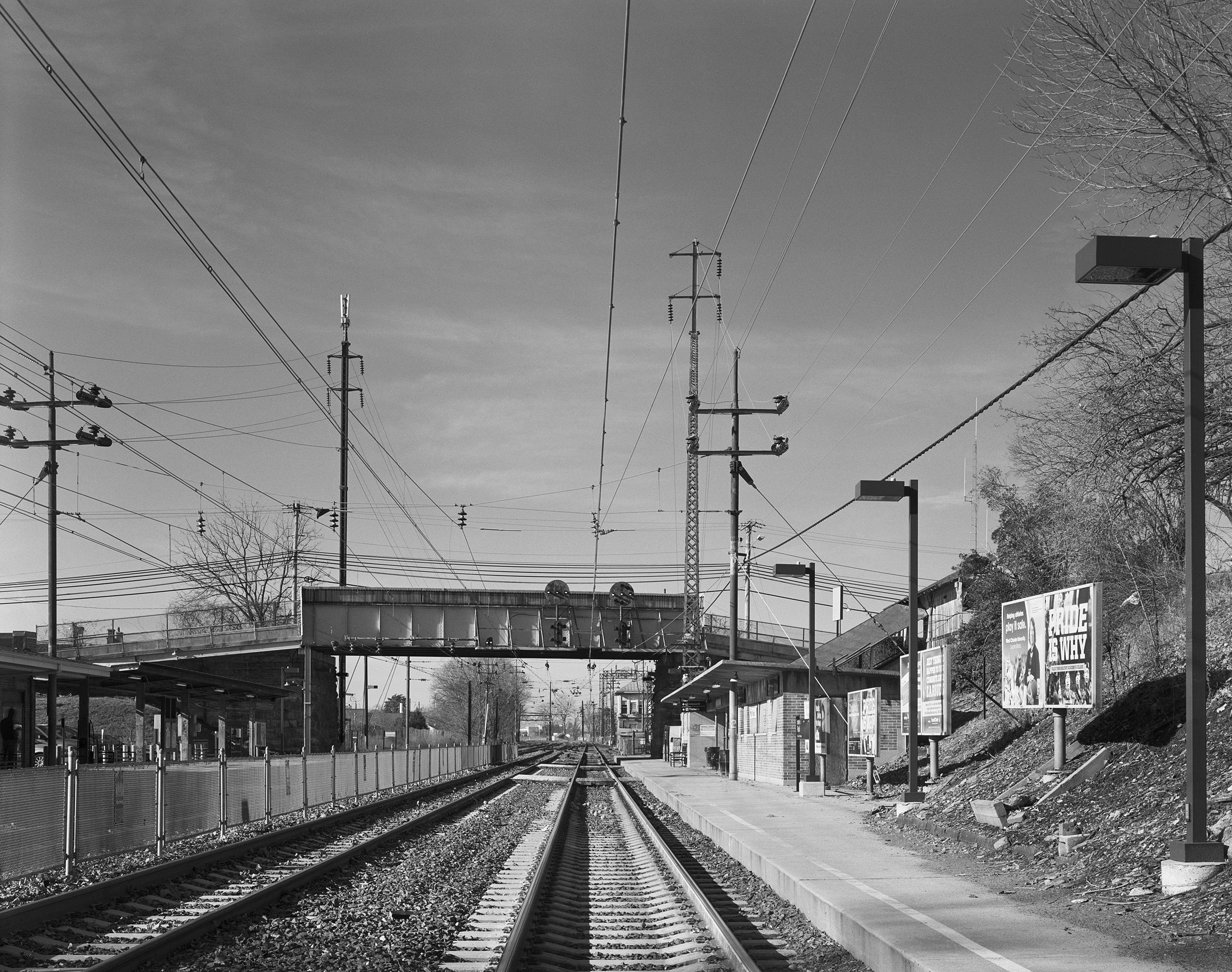 The western terminus of the 1915 electrification was Paoli, Pennsylvania just 20 miles west of Broad Street Station. Here in a modern view we look west toward the interlocking tower and former shop facility used to service the MP54 MU cars. Telltale details of the 1915 electrification include both the lattice style and tubular trolley poles that support the catenary system. Note: This photograph was taken with Amtrak permission under watchman protection, the author does not condone any type of trespassing on railroad or private property. 