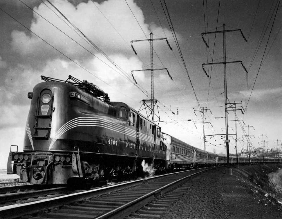 Class GG1 electric locomotive number 4868 pulls The Congressional circa 1965. Amtrak's AEM-7 was the successor of the highly regarded GG-1 both of which had successful careers on the Northeast Corridor, only time will tell if the Siemens ACS-64 will prove to be a worthy replacement.