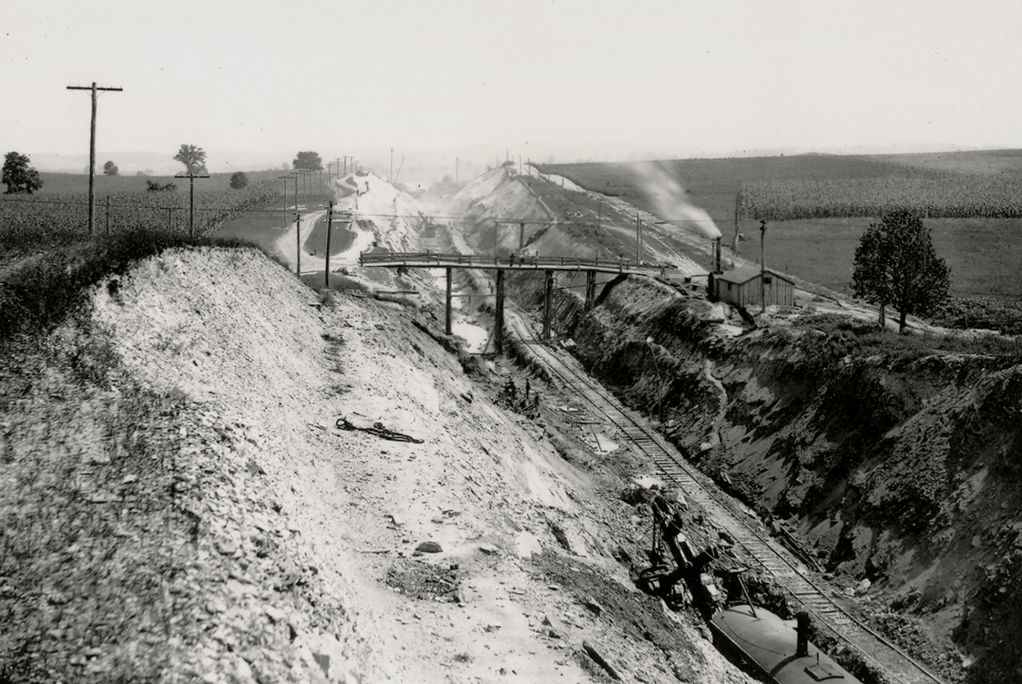 This cut excavated on the Manor Township section of the Atglen and Susquehanna illustrates the massive scope of ongoing work. The temporary narrow gauge track used to haul some of the 1.3 million cubic yards of debris is evident in the cut complete with a steam shovel at lower right, one of the key pieces of equipment for such work. Harry P. Stoner photograph, Columbia Historic Preservation Society