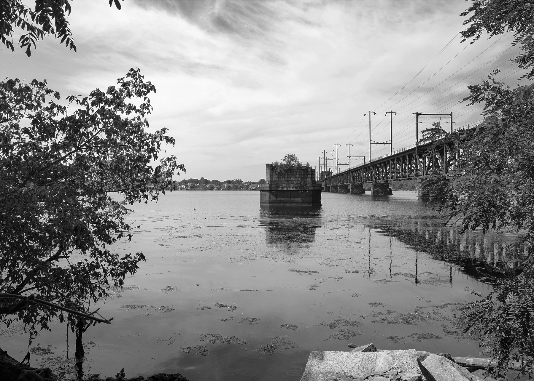 Susquehanna River Bridge, Perryville, Maryland. Images like this provide the visual clues of the evolution of the PRR network; the surviving piers of the 1866 Philadelphia, Wilmington & Baltimore Railroad bridge spanning the Susquehanna stands adjacent to its replacement completed by the Pennsylvania Railroad in 1906. Learn how I draw inspiration from historical imagery to create contemporary images that explore the surviving infrastructure of the PRR while considering its impact on the surrounding landscape. 