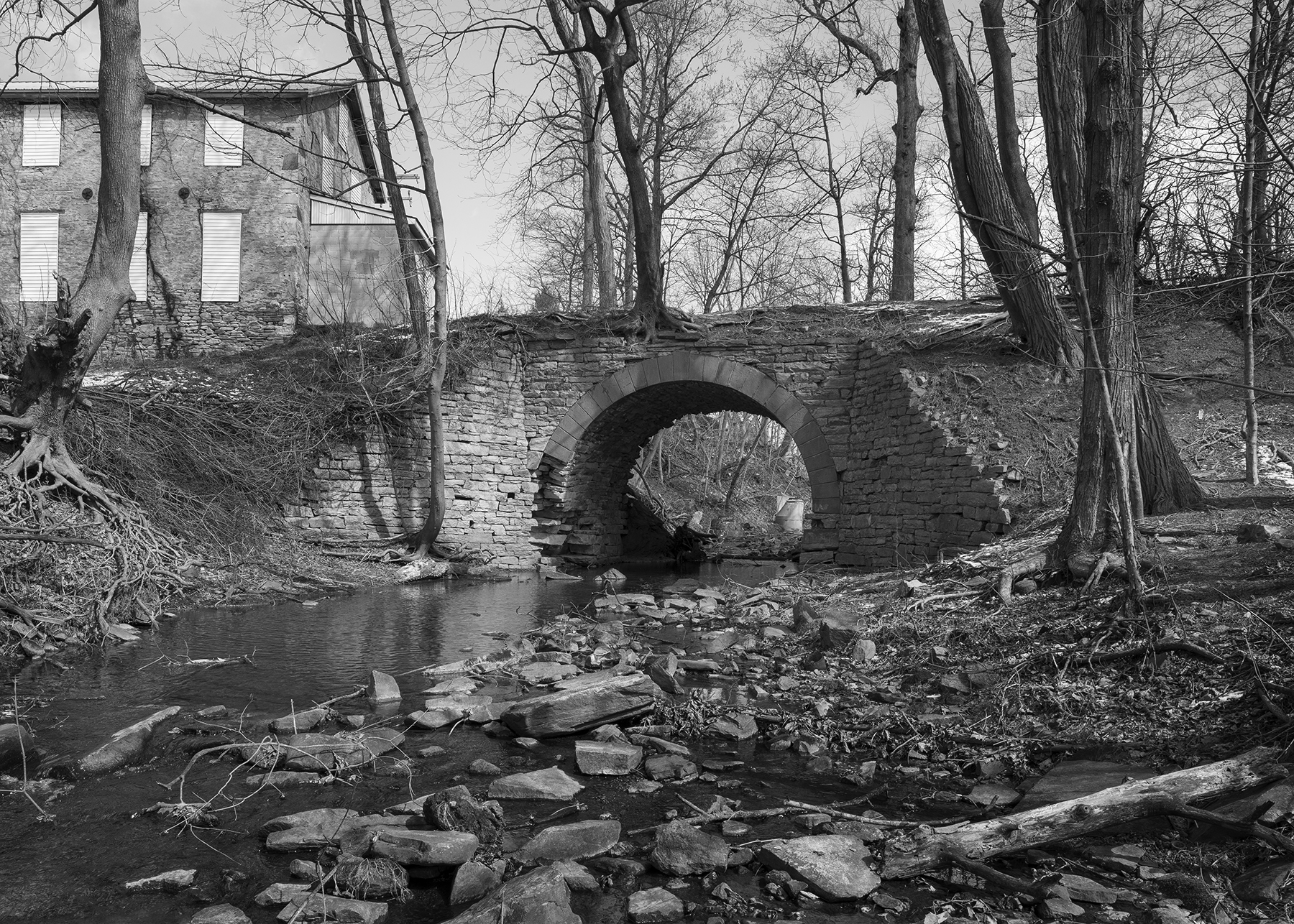 The remains of the original Philadelphia & Columbia stone arch bridge crossing Pine Creek still survive despite being part of the right of way that was abandoned during the 1890's line improvements between Gap and Atglen, Pennsylvania. The structures at the left are part of what was Christiana Machine, one of the first industries in Sadsbury Township to take advantage of the railroad's expanded market reach.