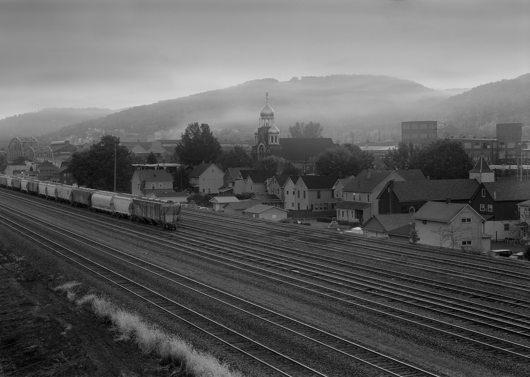 In Images like "Woodvale Yard, Franklin Boro, Pennsylvania", Rau's work both informs and inspires through understanding the history of place while responding to aesthetically choices like the use of light, composition and technical process. 