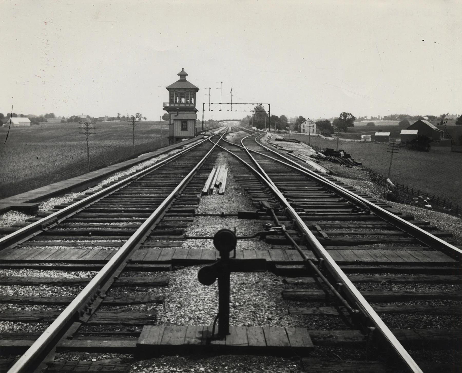 The western end of the Downingtown & Lancaster Branch joined the PRR Main Line just east of the Conestoga River bridge. This undated view of ES tower with its classic wood frame structure looks east on the main line where it collapses from four to two tracks to cross the Conestoga. Left and behind the tower you can see the diverging route of the D&L. Image is from the collection of the Lancaster History Archive