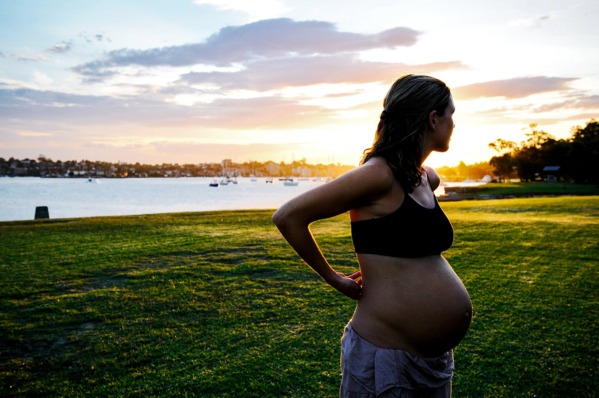 Pregnant woman looking at sunset at Woolwich NSW