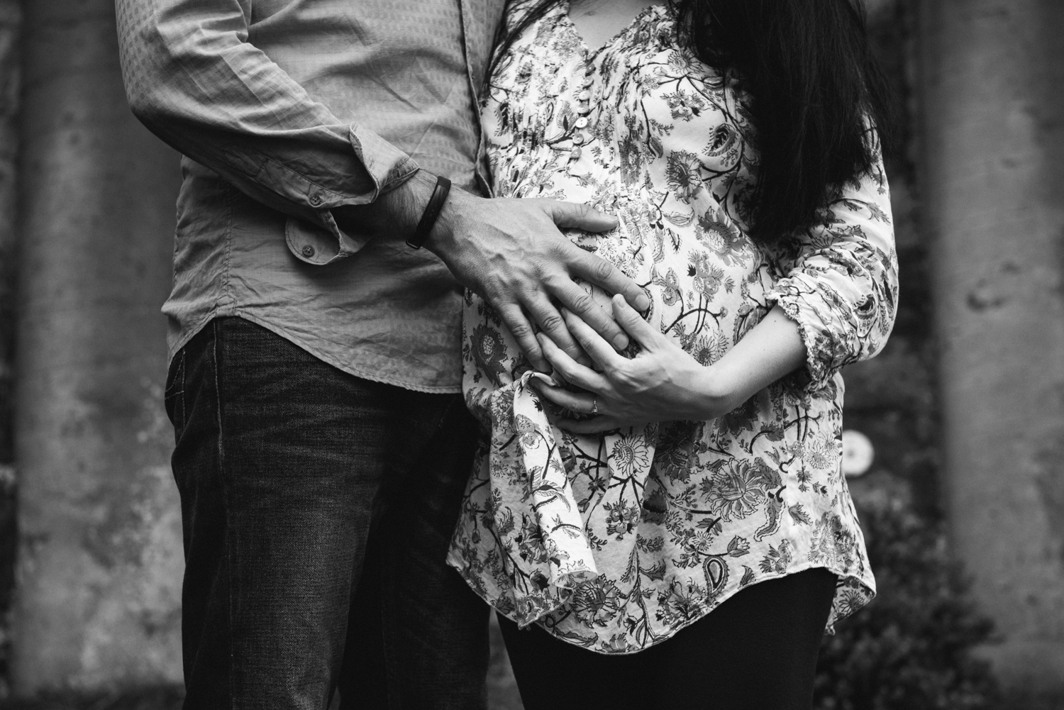 Close up of husband and wife holding pregnant belly