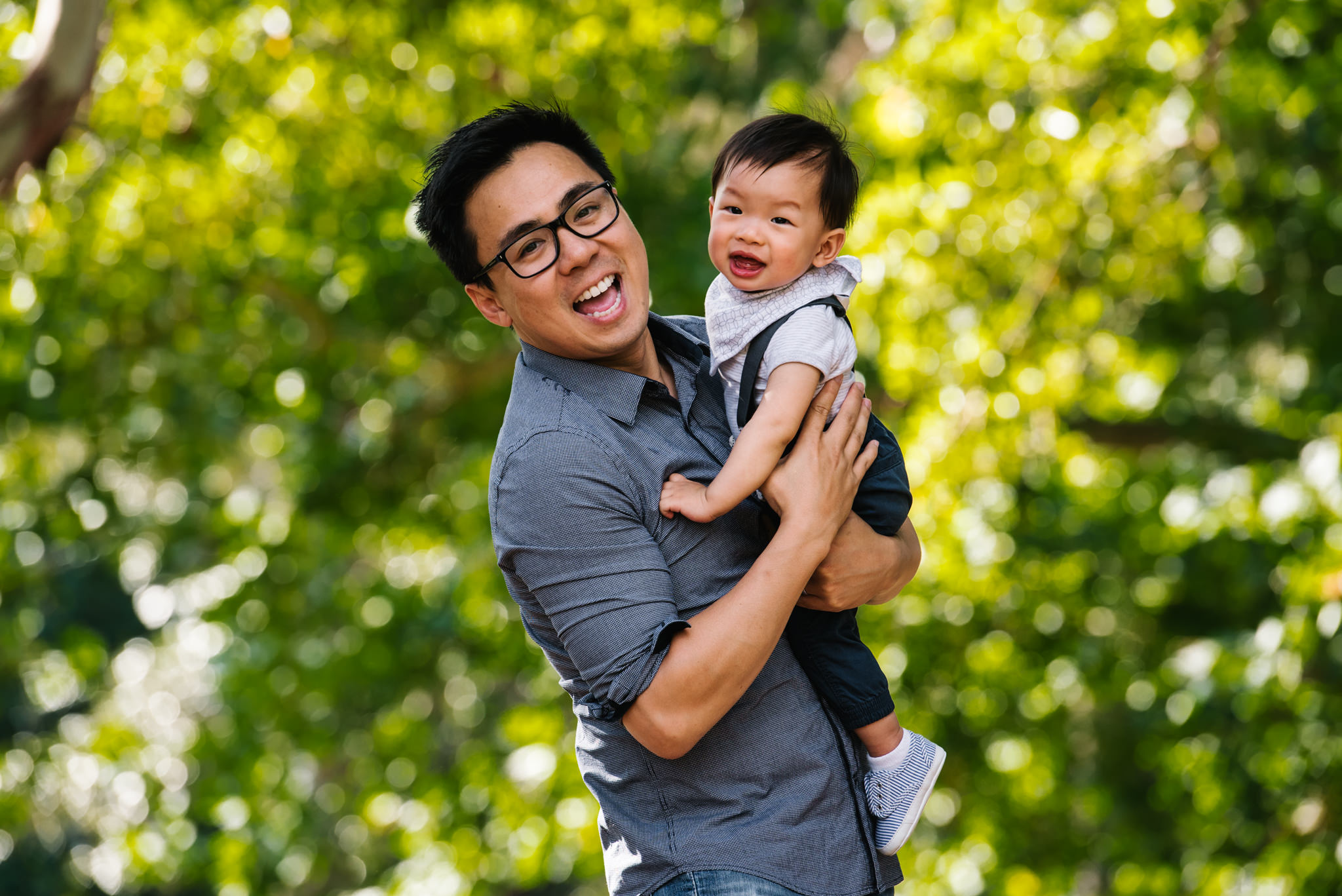 Father and son in leafy park