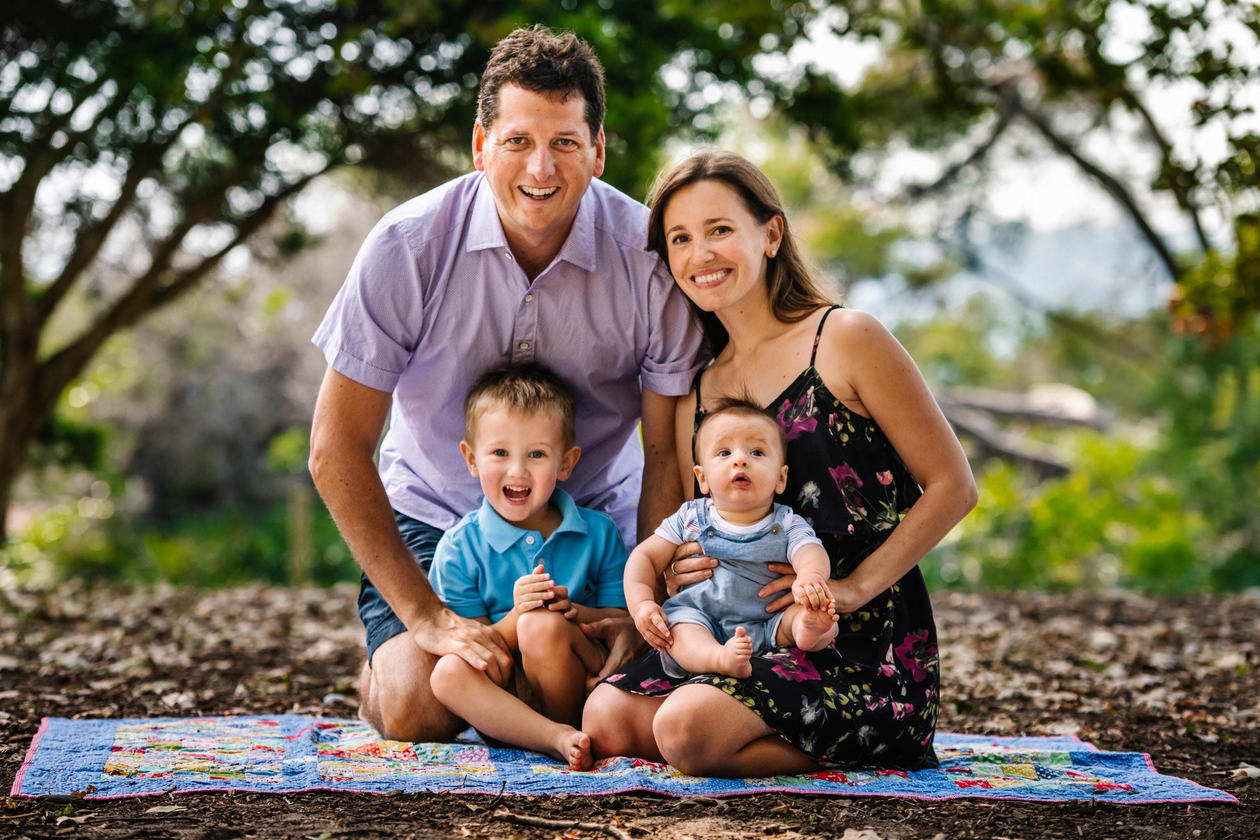 Family portrait with mum dad and two young boys smiling