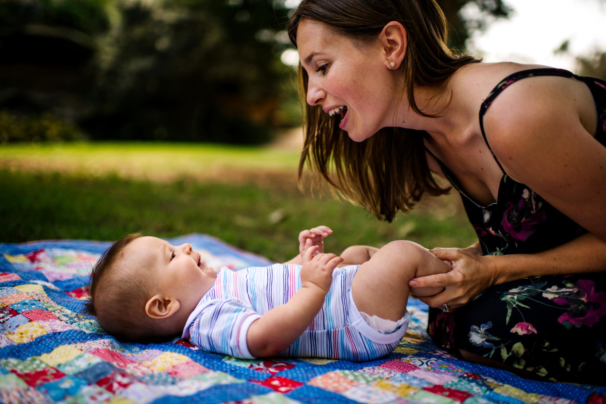 Mum and baby playing on the grass in Rosherville Reserve NSW