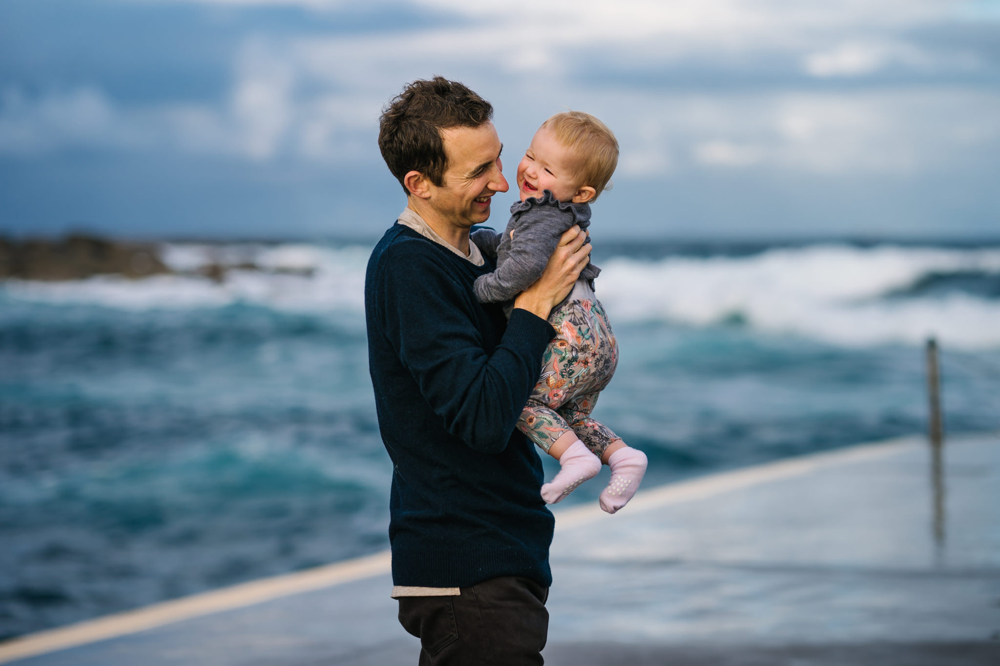 Baby and dad playing during Coogee Beach family photo session