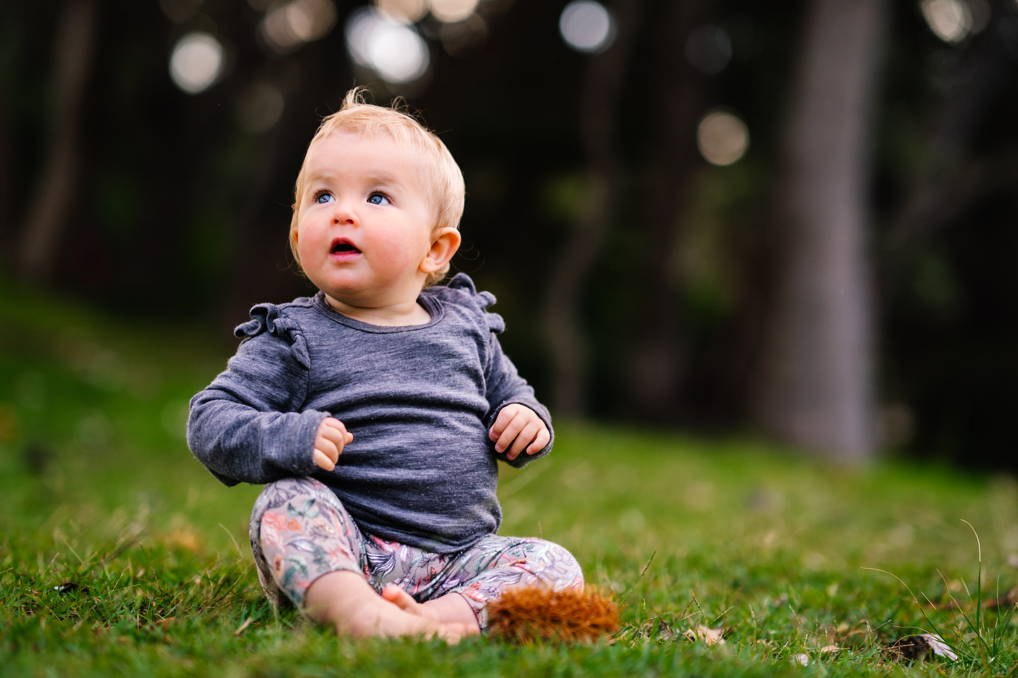 Baby girl sitting on the grass during Sydney family photography session