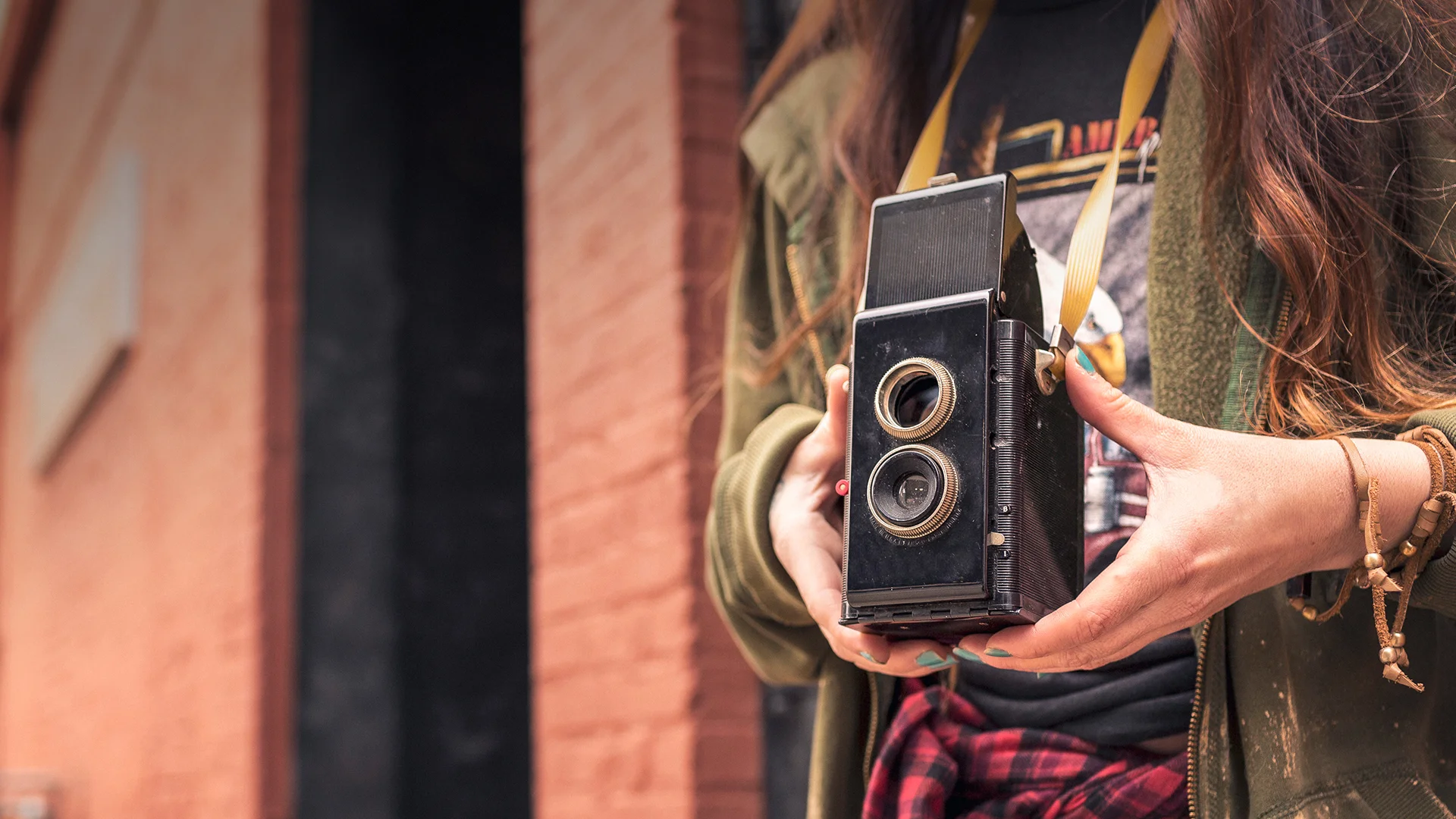 Student holding antique camera