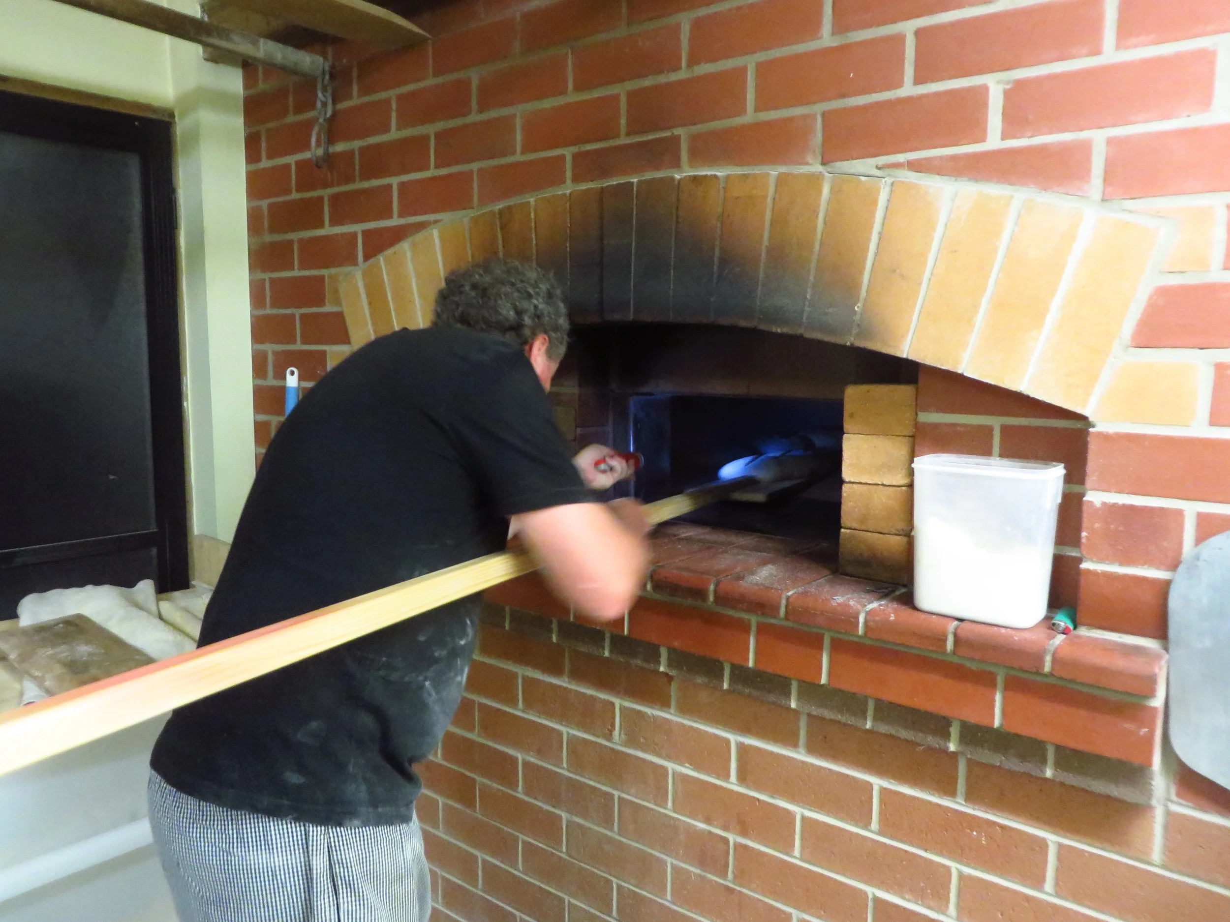 The loaves are then loaded onto the wooden peel, slashed and loaded into the oven.