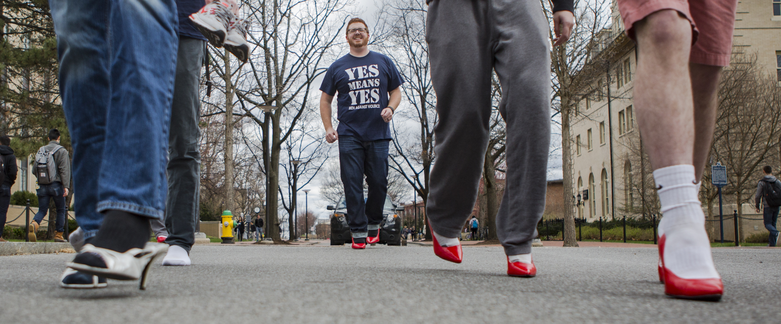 Director of Men Against Violence, Tim Donovan (graduate - higher education) brings up the rear of the Walk a Mile in Her Shoes march on Pollock Street on Monday, March 28, 2016.