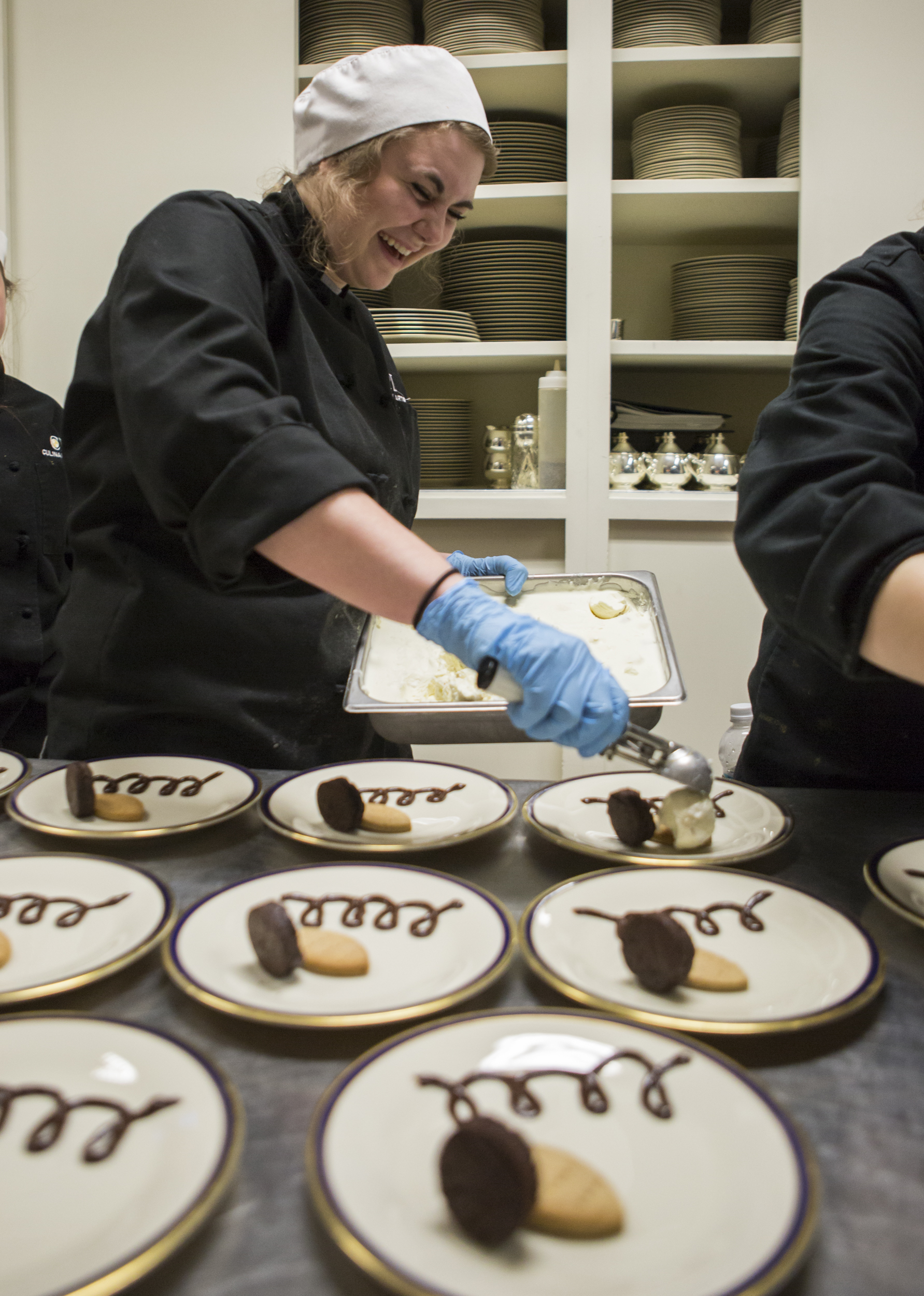 CPI culinary student Gillian Stewart scoops ice cream for the deconstructed s'mores served as dessert as part of the dinner prepared for Gov. Tom Wolf and Centre County administrators by CPI students at the Governor's Residence in Harrisburg on Monday, April, 1, 2016.