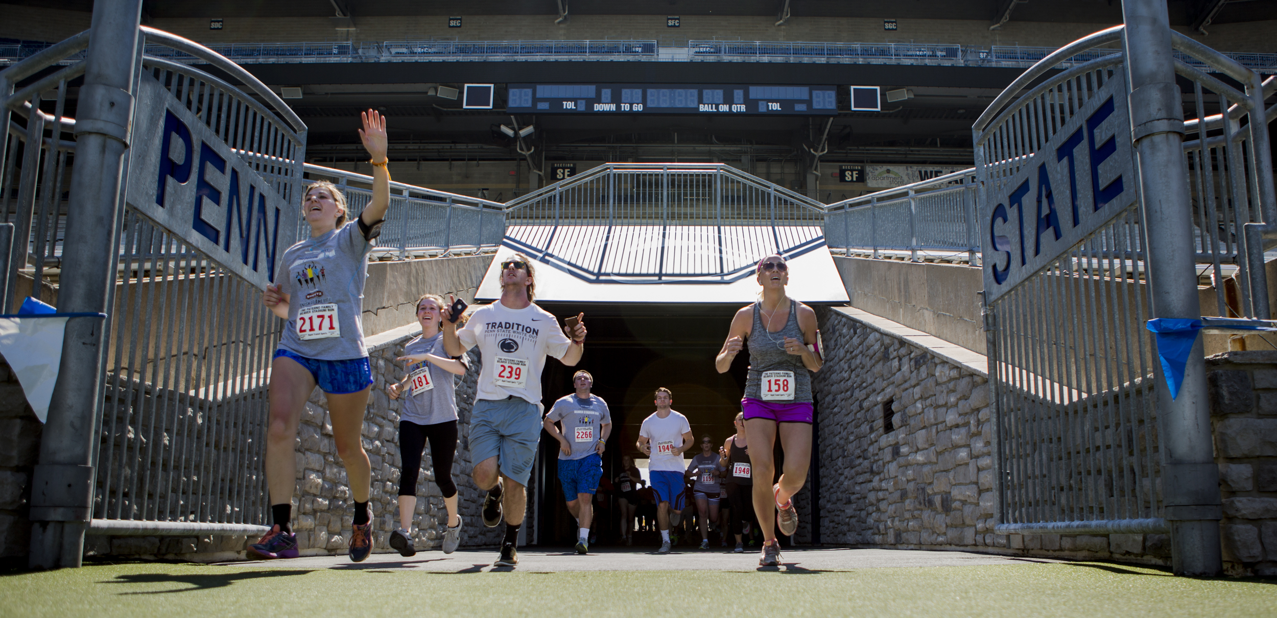 Participants of the annual Paterno Family Beaver Stadium Run enter Beaver Stadium through the player's tunnel for the final stretch of the run on Sunday, April 17, 2016.